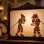 Colorful Karagöz and Hacivat leather shadow puppets on an illuminated traditional theatre screen