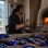 Craftsperson shaping a blue nazar boncuğu glass bead at a furnace in Nazarköy near İzmir